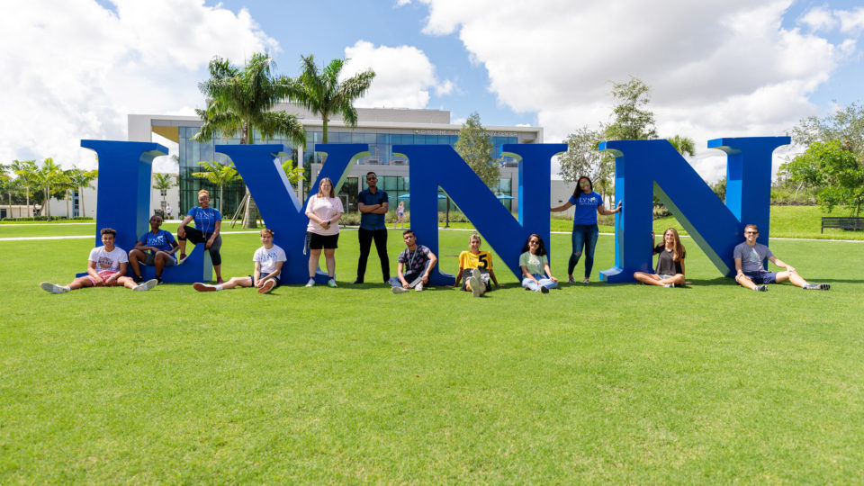 Freshman pose in front of the Lynn University letters.