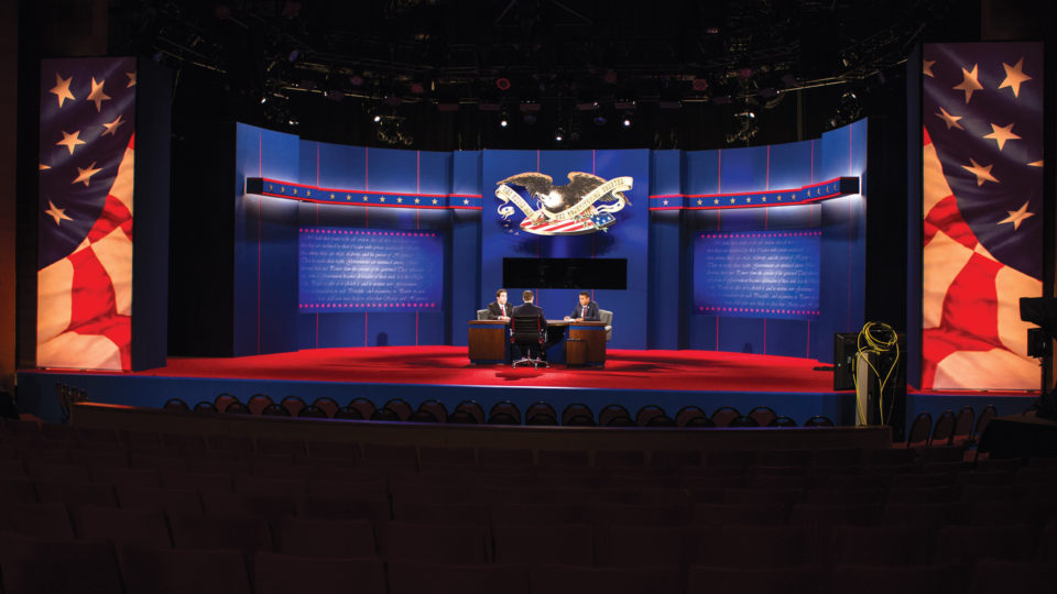 Presidential debate stage with student stand-ins
