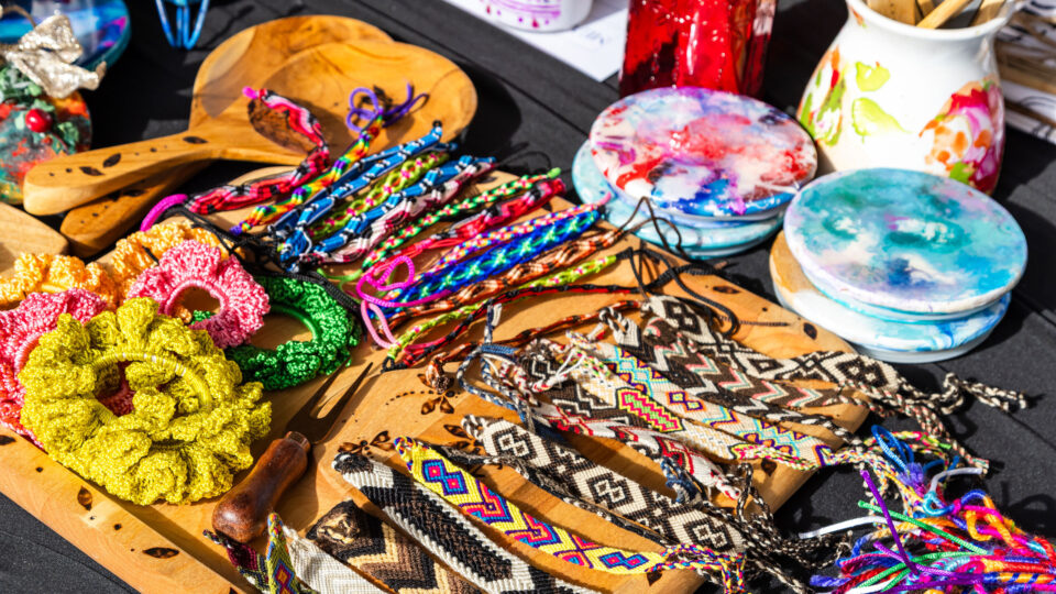 Goods and handmade crafts displayed on a table during the Global Village Holiday Market.