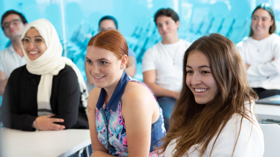 Students smiling during a lecture at the Snyder Idea Lab