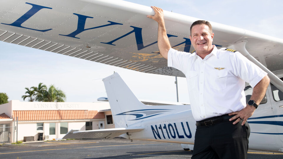 David Cohen, dean of aeronautics, stands in front of Lynn's Cessna aircraft
