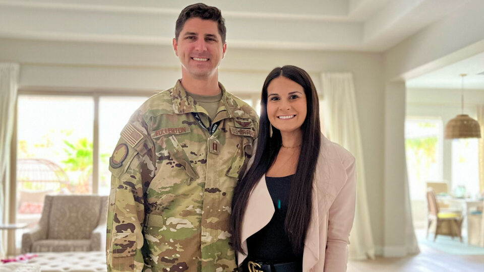 Alumni Monica Fullerton poses with her husband in their house