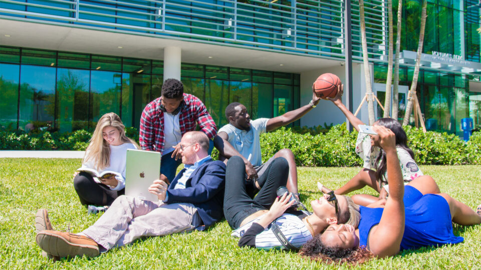Students hang out on the lawn in front of the Mohammed Indimi International Business Center.