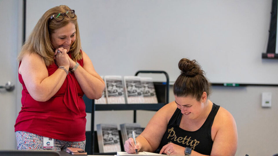 Steph Roach signs her book for a fan.