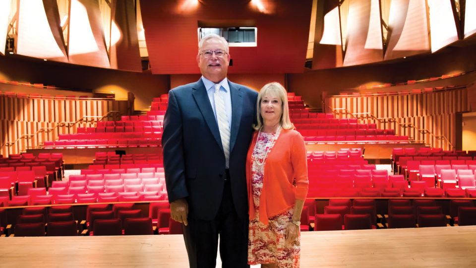 Douglass Kay, M.D., and Susan Kay standing on the Wold stage